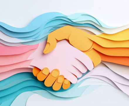 Colorful paper cutouts form two hands shaking, with layered pastel waves in the background, symbolizing unity, collaboration, and creativity.