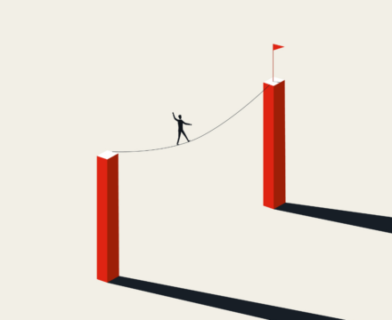 A person balances on a tightrope stretched between two tall red pillars, heading toward a small red flag on the far pillar. The scene is minimalistic with long shadows cast on a light background.